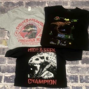 Two Jurassic World and one Jurassic Park shirts, size M/10-12